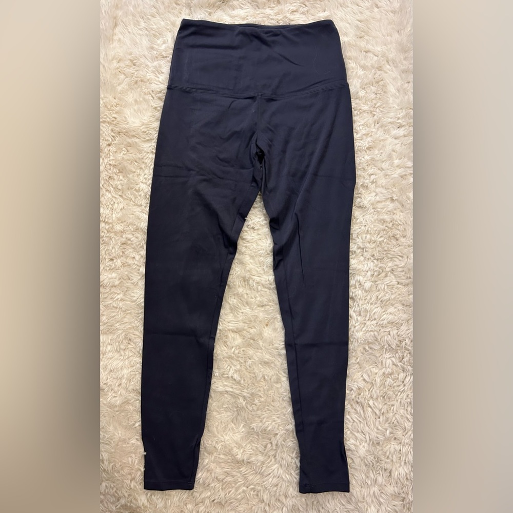 These are a pair of Tuff Athletics leggings in the size small. They are navy.